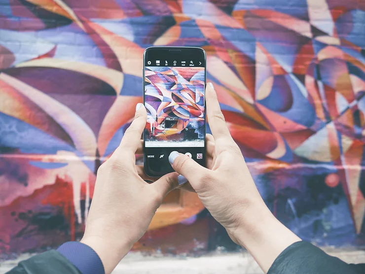 a phone taking a photo of a mural