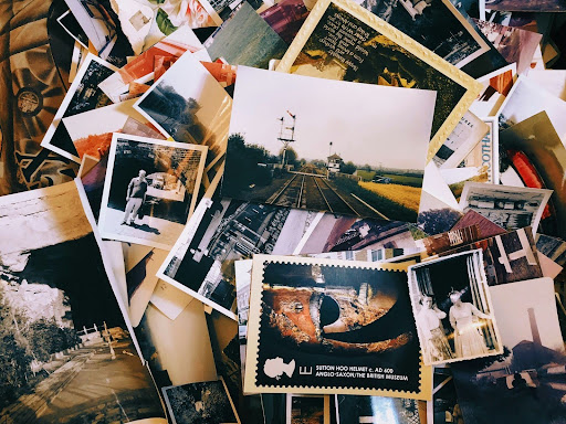 a stack of photos scattered in a cluttered pile that should be digital organized